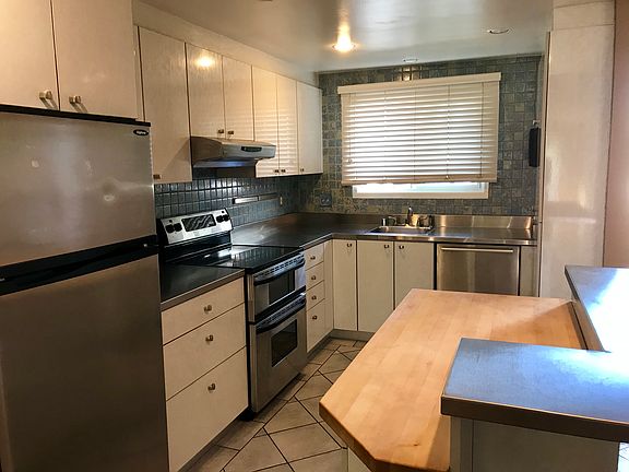 Butcher block island and stainless steel countertops.