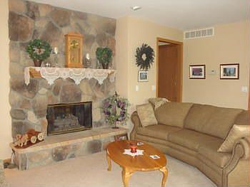 Family room is very comfy, shared gas fireplace between this room and room pictured above.