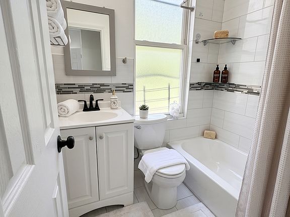 Bathroom- This room has been virtually staged using AI to help visualize its layout and design potential.