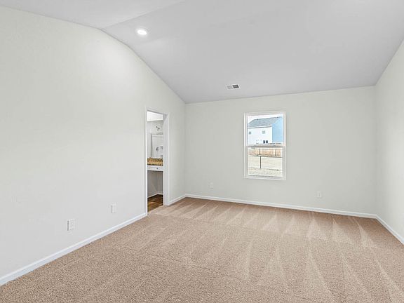 Master suite with vaulted ceiling