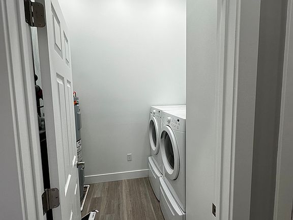 In unit laundry room with full sized HE washer and dryer