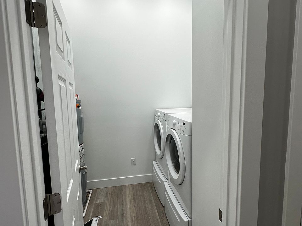 In unit laundry room with full sized HE washer and dryer