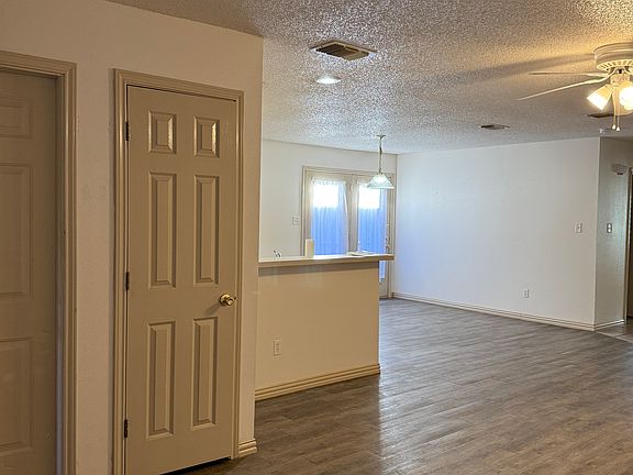 From corner of LR showing door to garage(left), Entrance closet, LR, DR, and wall to kitchen on left -hall to Laundry/Hall bath, and BRs on right