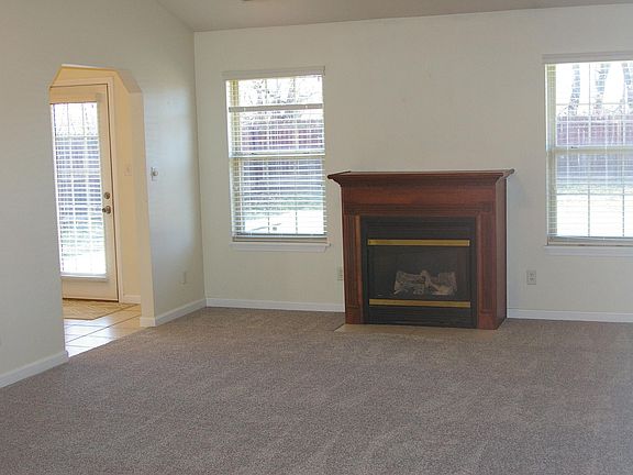 Vaulted great room with ceiling fan that flows nicely into kitchen area and dining area. Cherrywood gas fireplace is the central focus of the room. Fresh carpet throughout house.