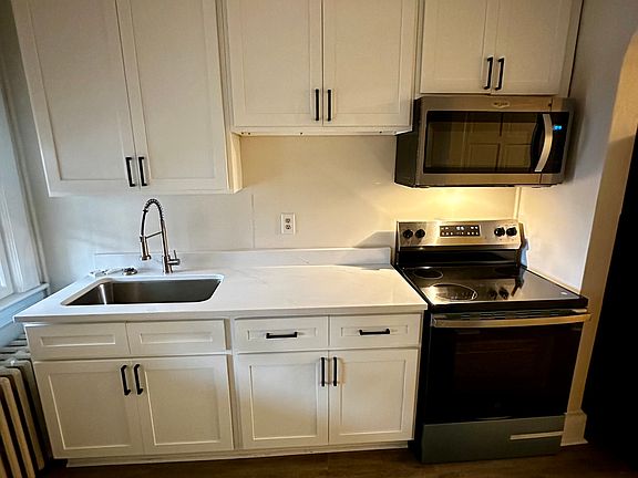Completely renovated kitchen with new cabinets, white quartz countertops, and all new stainless steel appliances.