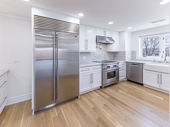 Kitchen with Subzero Fridge, Kohler Farmhouse sink, Wolf Range and Quartzite Counter