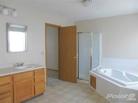 Massive Owner's Suite Bath features garden tub; Jack and Jill sinks; walk-in closet; beautiful flooring and stand-a-lone shower.