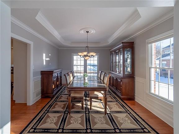 Step through cased doorways leading to the exceptional dining room boasting oft modern tones, custom details throughout includin