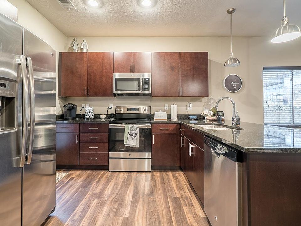 Our traditional design scheme features rich, dark cabinetry with darker granite countertops.