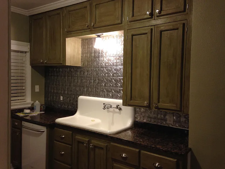 Granite, original washboard sink. Lots of storage!