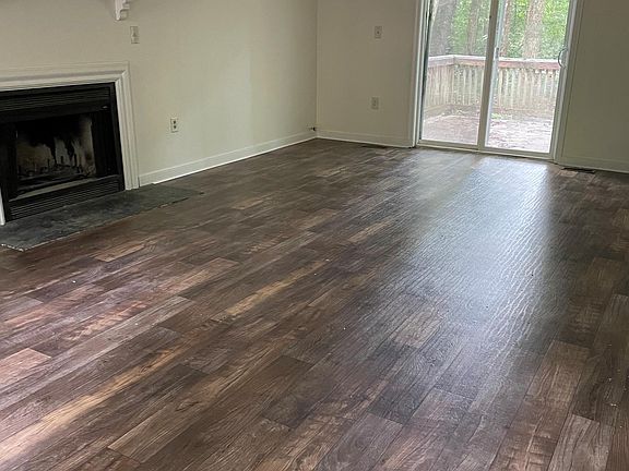 Spacious Great Room - woodburning fireplace, access to back deck and private back yard.