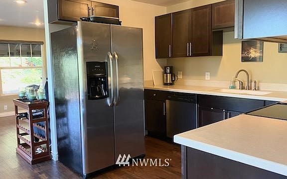 Beautiful rich cabinets and stainless steel appliances in the kitchen. All appliances stay! 