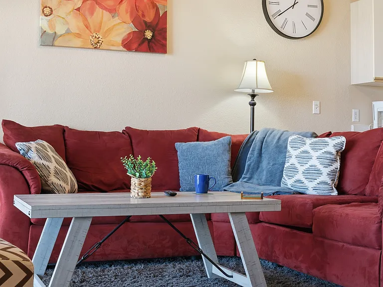 Fully furnished living area with ceiling fan