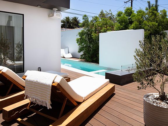 Meet your preferred area lounging! Right on the pool by the fire pit. Enjoy this sitting area having you coffee, laptop, or enjoy a glass of wine watching an outdoor movie.