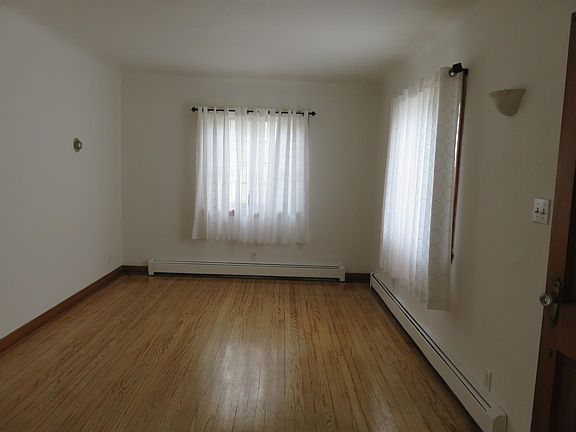 Living room has 2 original sliding windows, coved ceilings a