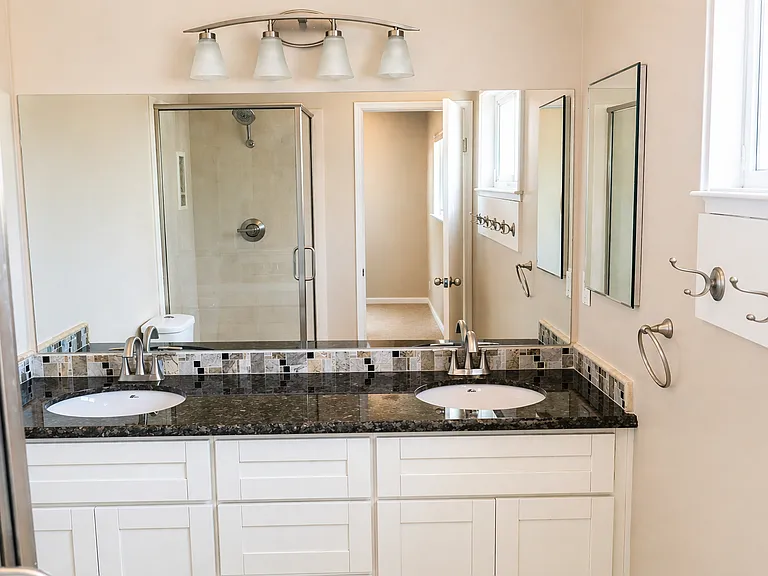 Master bath with double vanity and shower.