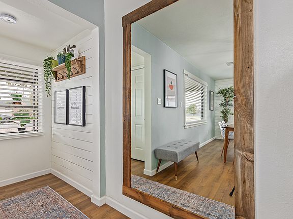 Entryway with plenty of natural light and full-length mirror.