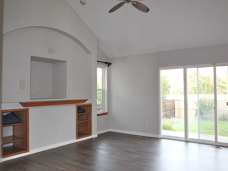 Spacious great room with vaulted ceilings and access to back patio. Great room measures 15'5" by 14'2"