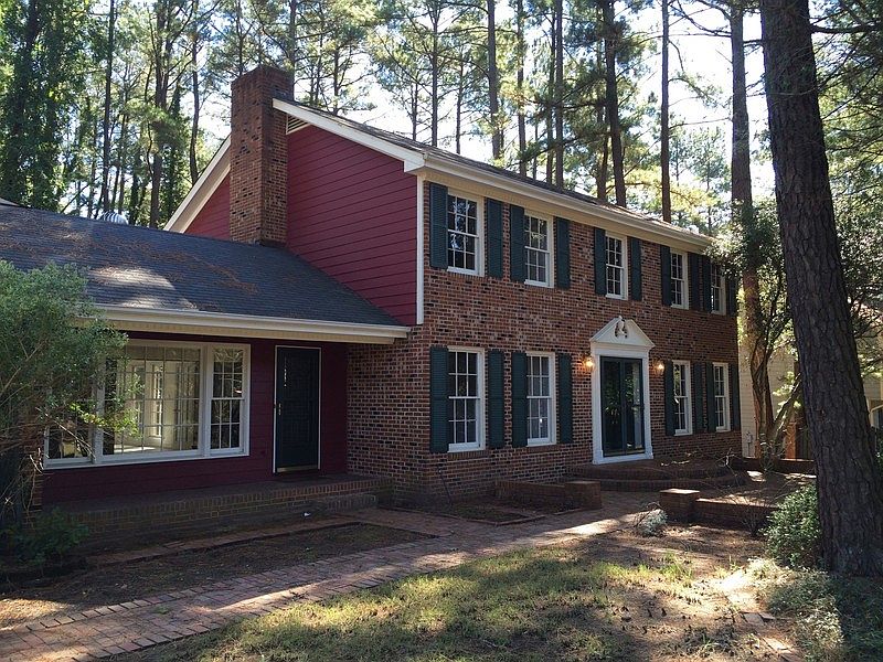 Mostly brick exterior with brick walkway and porches.