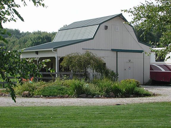 32' x 40' barn with hayloft, two stalls, storage space, 60 amp service 