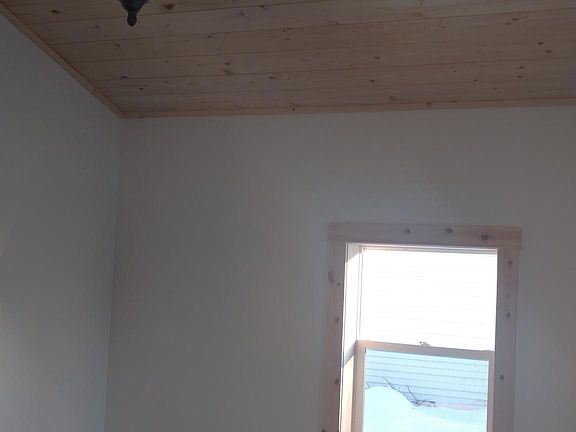 Living room, with vaulted wood ceiling, chandelier, and luxu