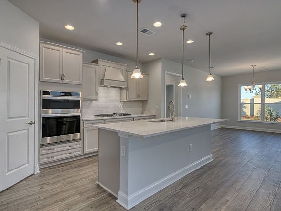 The kitchen island provides additional seating opportunities for guests and space to prepare meals.
