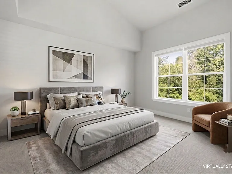 Primary bedroom ensuite features a vaulted ceiling, walk-in closet and faces a serene wooded backdrop so it's pin-drop quiet.