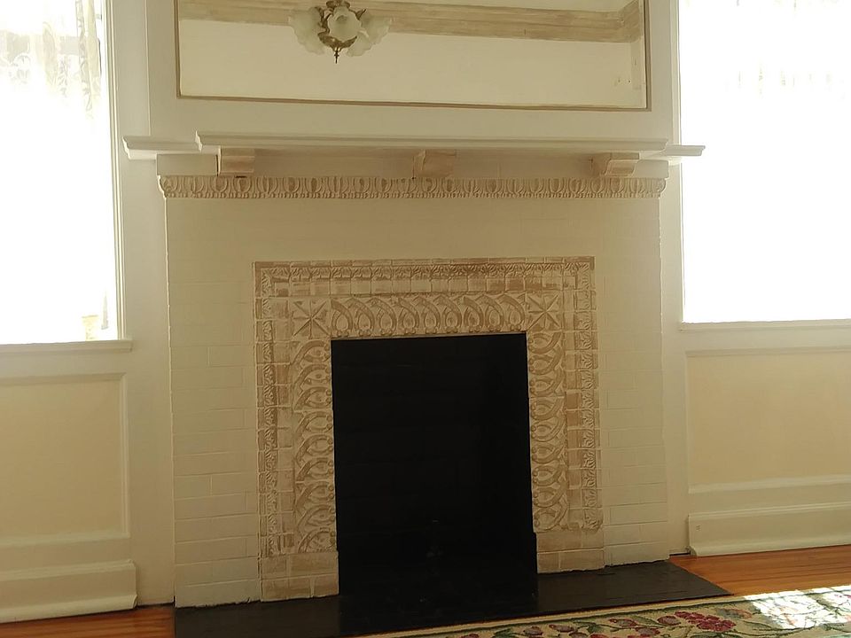Century architecture with original fireplace in spacious entry foyer