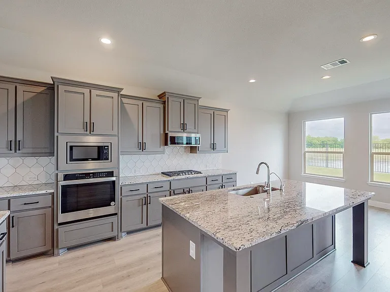 Enjoy the stunning gray cabinets for depth and storage