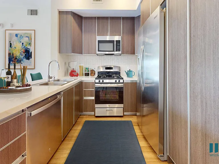 Open-Concept Kitchen with Countertop Bar and Stainless-Steel Appliances