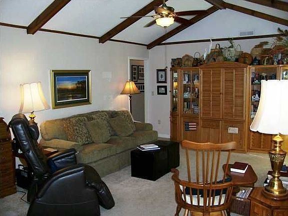 Spacious Family Room has glass paned door with screen door leading to patio