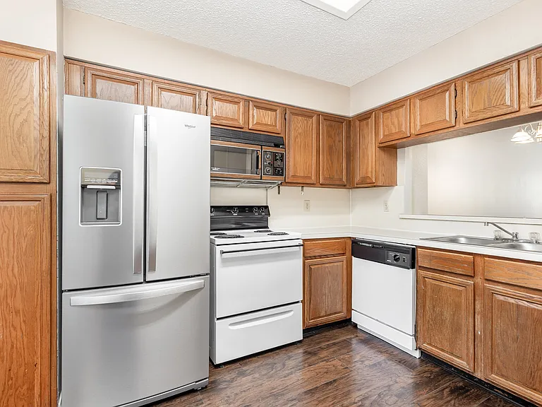 Kitchen with double sided refrigerator, drawer freezer, built in microwave and refrigerator.