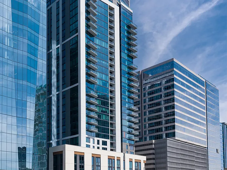 Street-level view of a Modera McGavock with glass-forward architecture, private balconies, and a prime downtown location connecting residents to Nashville.