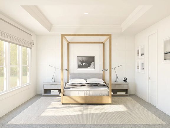 Primary suite with decorative feature wall and tray ceiling with crown moulding