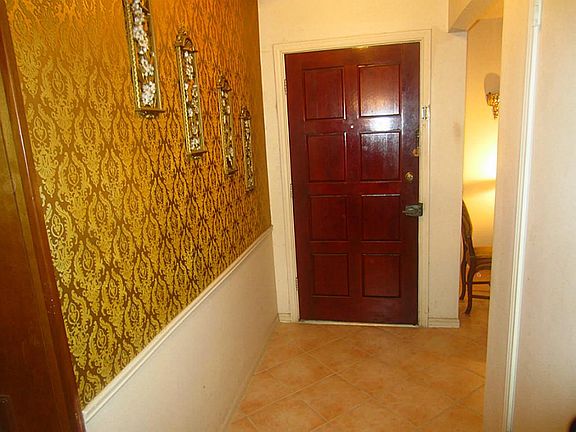 Entrance hallway with tile floors.