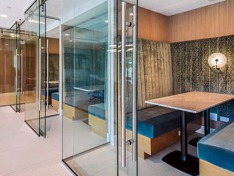 Griffis West Palm apartments coworking lounge with glass walled coworking pods.
