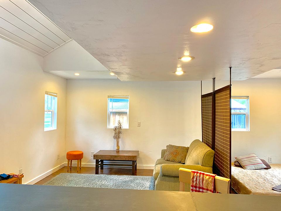 Living space and south-facing windows. That's the sleeping area to the right of the privacy screen.