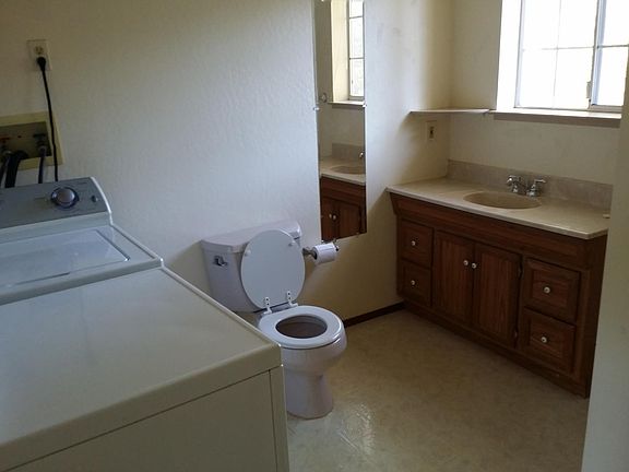 Master bathroom with shower and washer and dryer