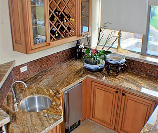 Sunken Wet Bar has Brazilian and Italian granite countertops and maple cabinets