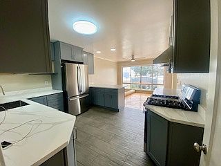 All NEW Kitchen with new ceramic tile flooring, NEW Cabinetry, and NEW Quartz Countertops with brand-new Gas Stove and brand-new vent hood, brand-new 27 cu. ft. French door Refrigerator