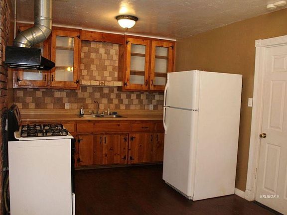 Kitchen with stove and refrigerator