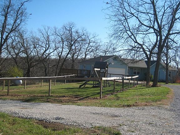 Deck and fenced yard with playset
