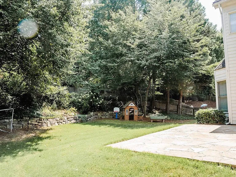 Landscaped backyard with stone patio