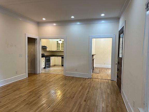 living room opens to both the kitchen and dining room (or home office).