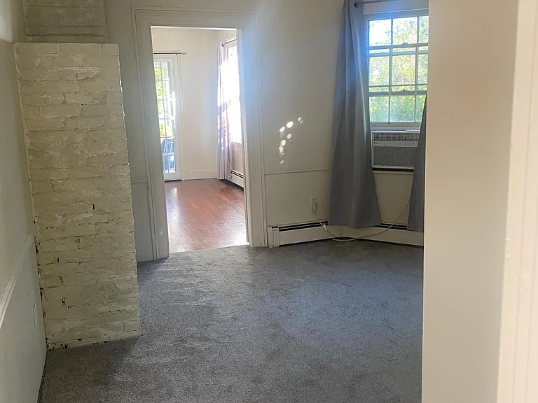 Cozy living room leading into bedroom.