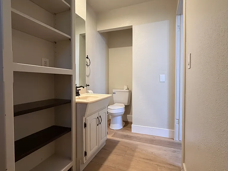 Downstairs bathroom off of kitchen with laundry facilities