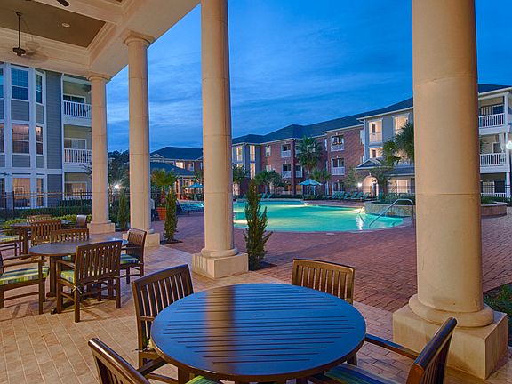 Outdoor Lounge with Dining & BBQ Area Overlooking Pool Deck