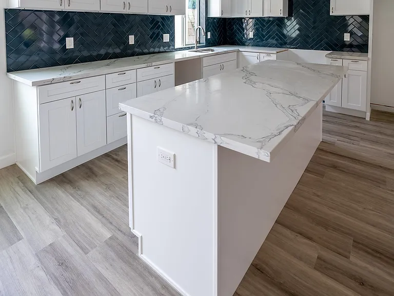 Gorgeous designer-styled kitchen with deep ocean blue herringbone tile
