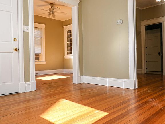 Living area and bedroom through door on the right