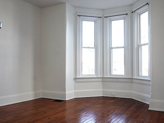 Beautiful bay window floods the living room with natural light.